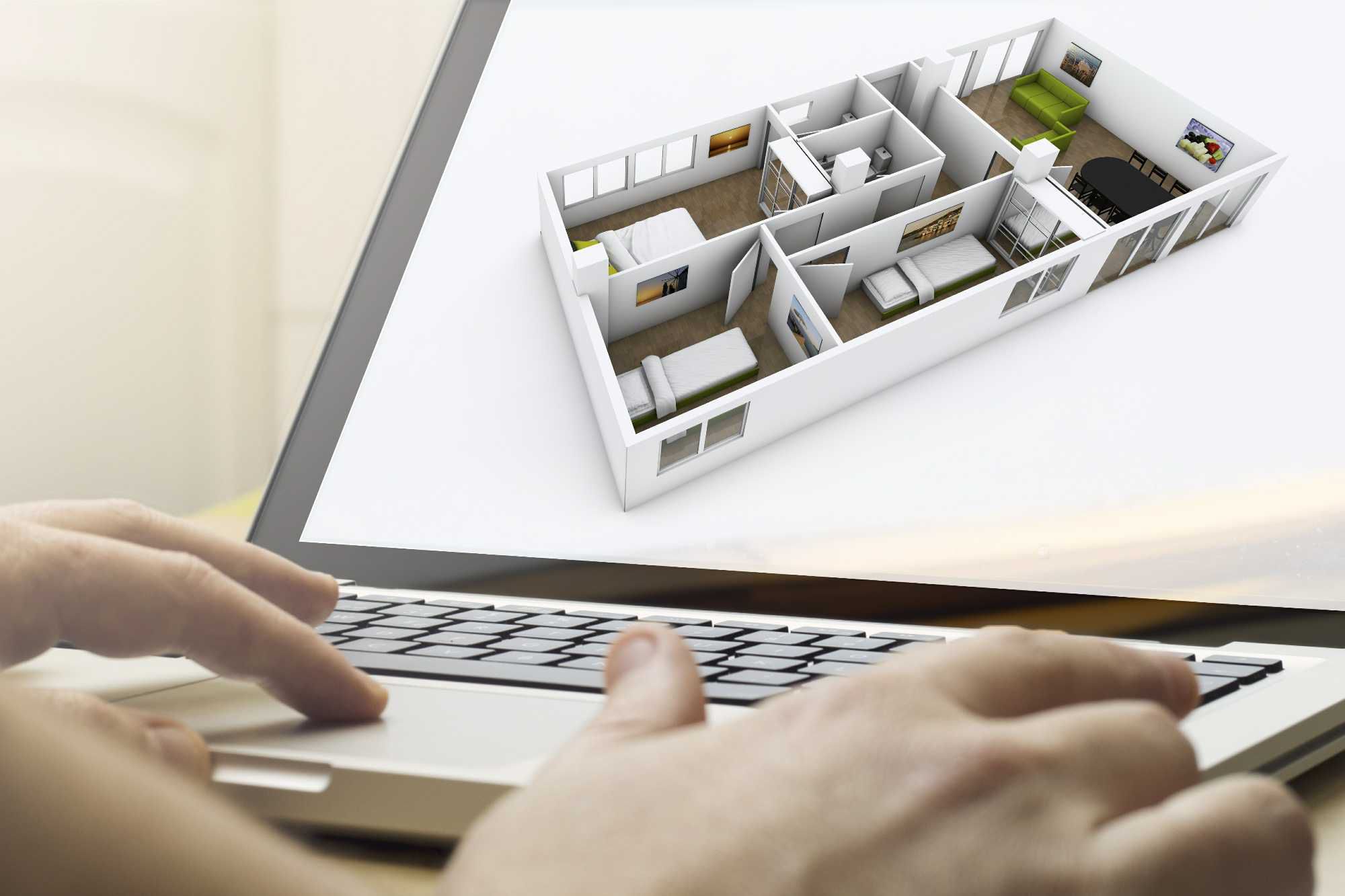 Picture of a 3 dimensional house on a computer screen with a mans hands typing on the keyboard